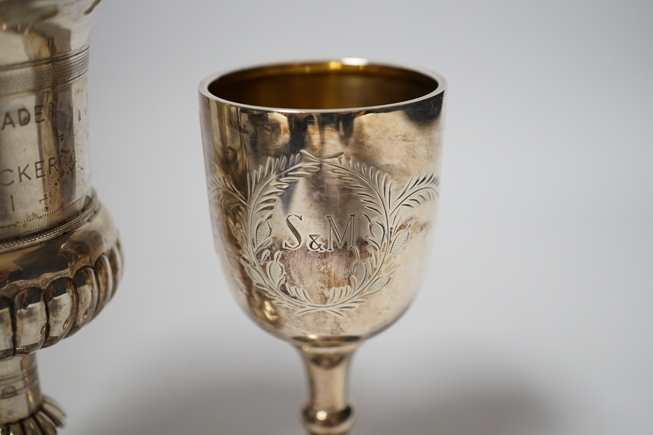 A small modern silver goblet, 11.2cm. and one other larger white metal goblet.